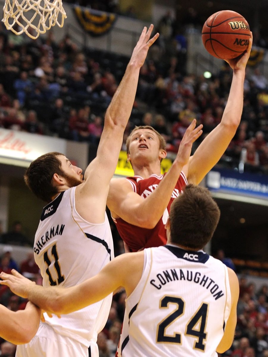 Indiana center Luke Fischer shoots over Notre Dame's Garrick Sherman on Dec. 14, 2013 in Indianapolis, Ind.