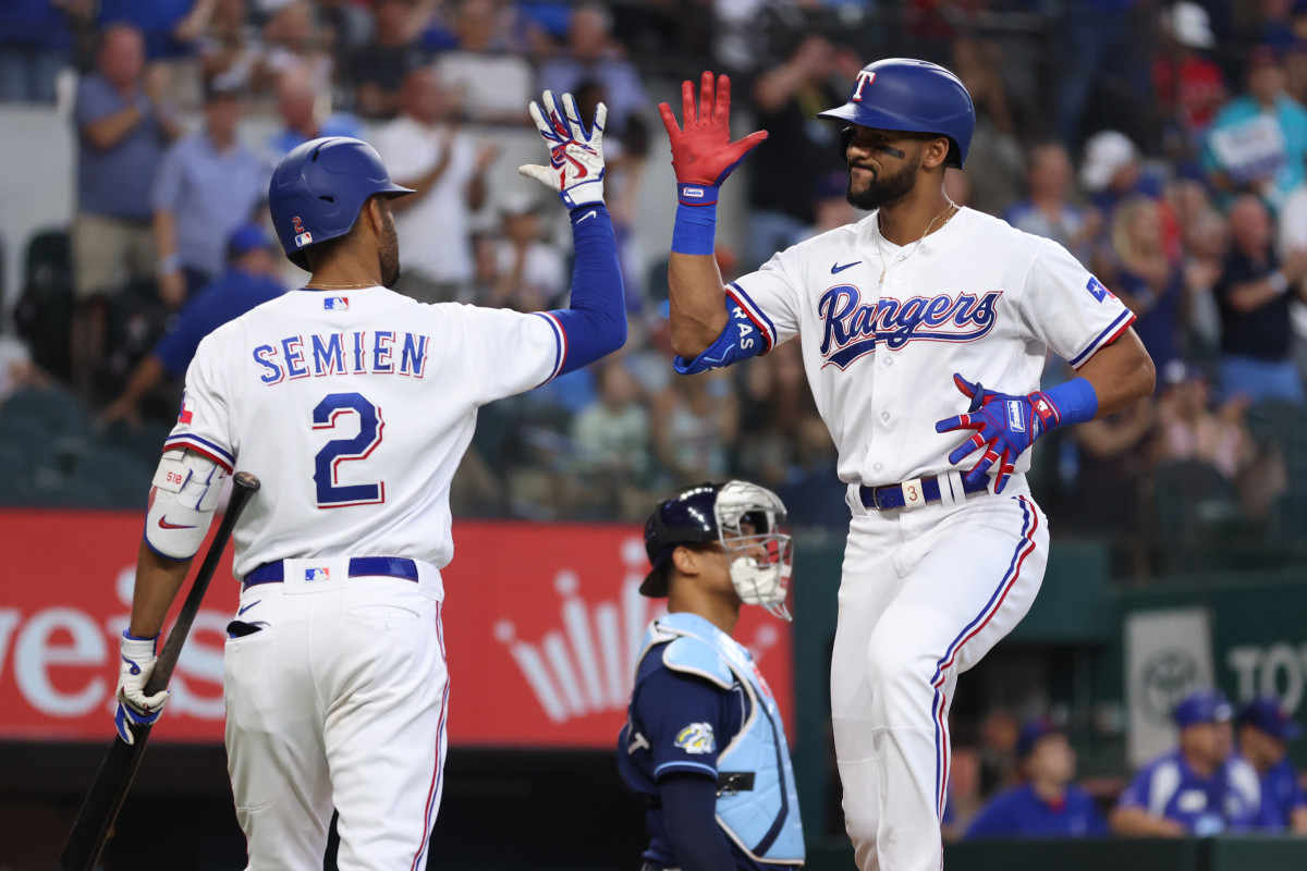 exas Rangers center fielder Leody Taveras, right, is congratulated by second baseman Marcus Semien after hitting a solo home run in the third inning Wednesday against the Tampa Bay Rays at Globe Life Field.