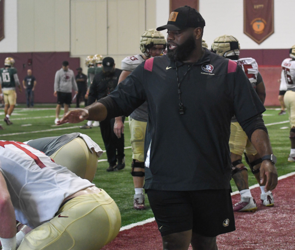 Florida State offensive coordinator Alex Atkins (right) coaches his offensive line up during an FSU spring football practice of the 2023 season on Friday, March 10, 2023.