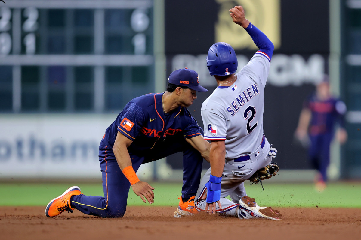 Houston Astros shortstop Jeremy Pena, left, tags out Texas Rangers second baseman Marcus Semien on a stolen base attempt during the fourth inning Monday at Minute Maid Park.