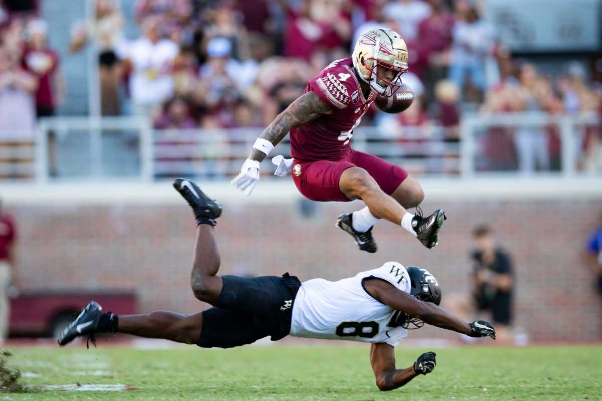 Florida State Seminoles wide receiver Mycah Pittman (4) leaps over a defender as he avoids a tackle. The Florida State Seminoles lost to the Wake Forest Demon Deacons 31-21 Saturday, Oct. 1, 2022. Fsu V Wake Forest Second768