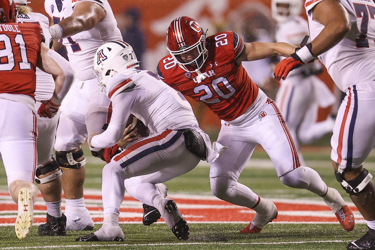 Nov 5, 2022; Salt Lake City, Utah, USA; Arizona Wildcats quarterback Jayden de Laura (7) is tackled by Utah Utes linebacker Lander Barton (20) in the third quarter at Rice-Eccles Stadium. Mandatory Credit: Rob Gray-USA TODAY Sports