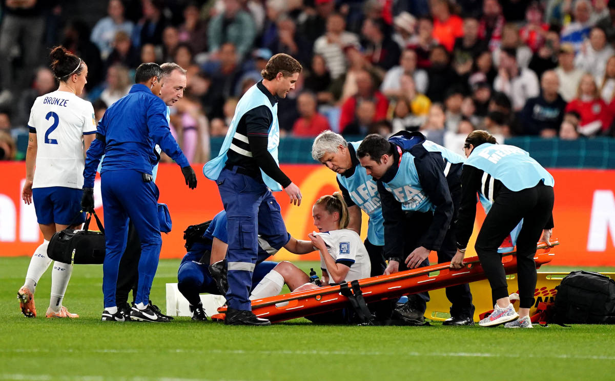 England midfielder Keira Walsh pictured (center) surrounded by medical staff after suffering a knee injury during her team's 1-0 win over Denmark during the 2023 Women's World Cup group stage