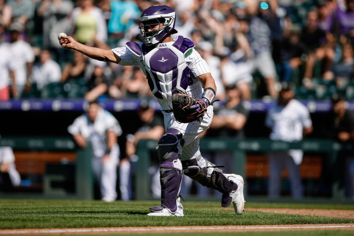 Elias Díaz throws the ball in his catchers pads