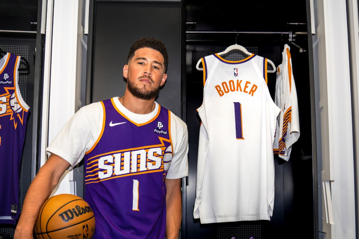 Phoenix Suns SG Devin Booker shows off the new uniforms.