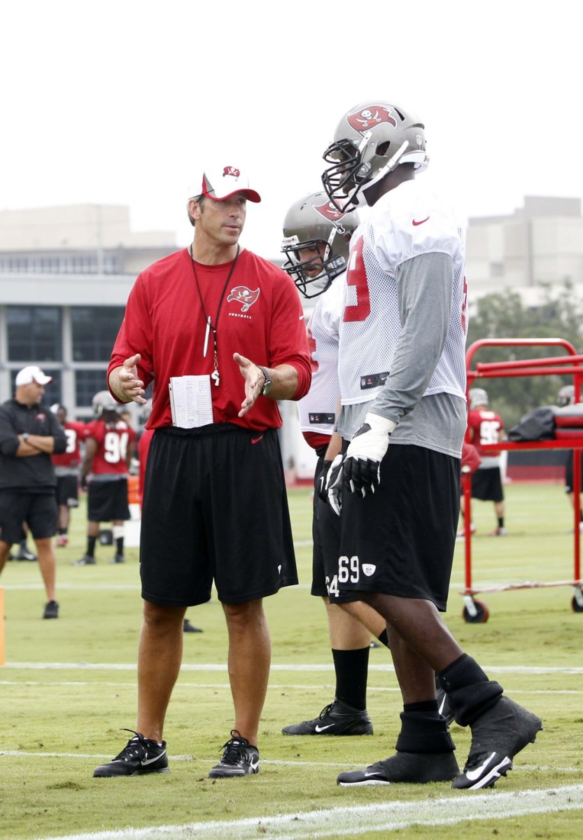 Bostad instructing NFL offensive lineman Demar Dotson at his former job as offensive line coach for the Tampa Bay Buccaneers.