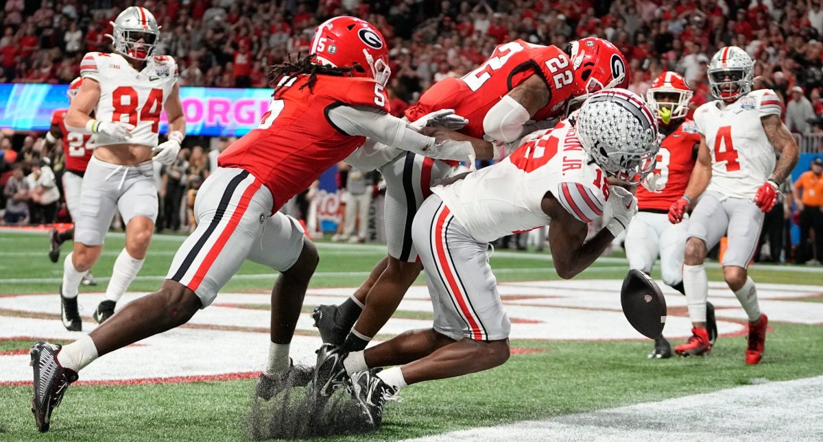 Georgia defender Javon Bullard (22) delivers a devastating blow to Ohio State WR Marvin Harrison Jr. in the 2022 Peach Bowl.