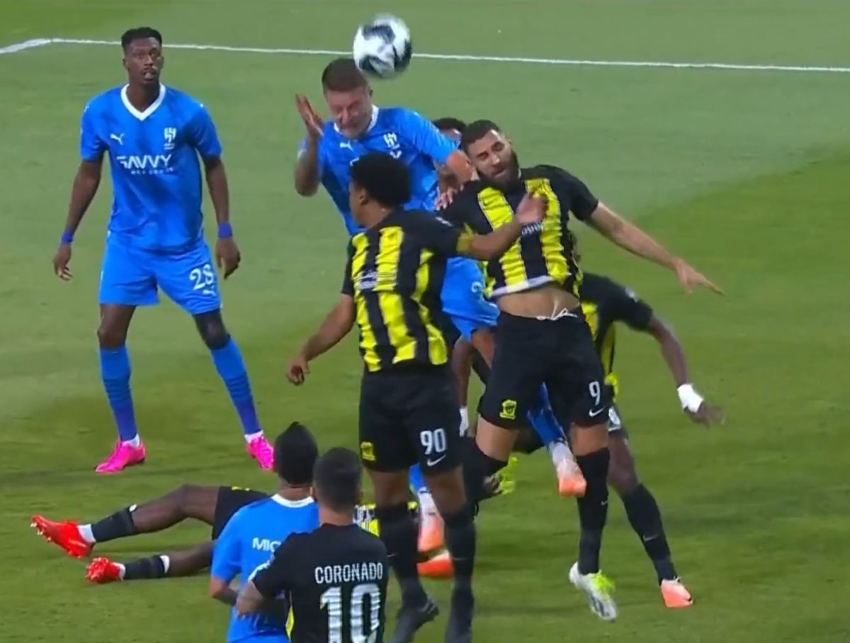 Sergej Milinkovic-Savic pictured in August 2023 heading the ball to score for Al-Hilal against Al-Ittihad after outjumping Karim Benzema (right)