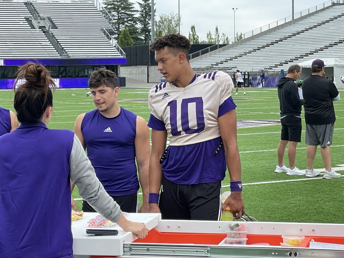 Austin Mack looks for a drink and snack on the field following Sunday's practice.