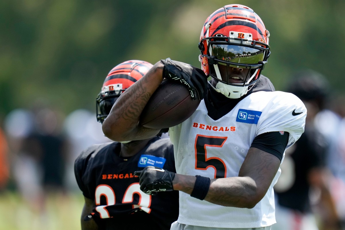 Cincinnati Bengals wide receiver Tee Higgins (5) runs from safety Nick Scott (33) with a catch during a training camp practice at the Paycor Stadium practice field in downtown Cincinnati on Friday, Aug. 4, 2023.