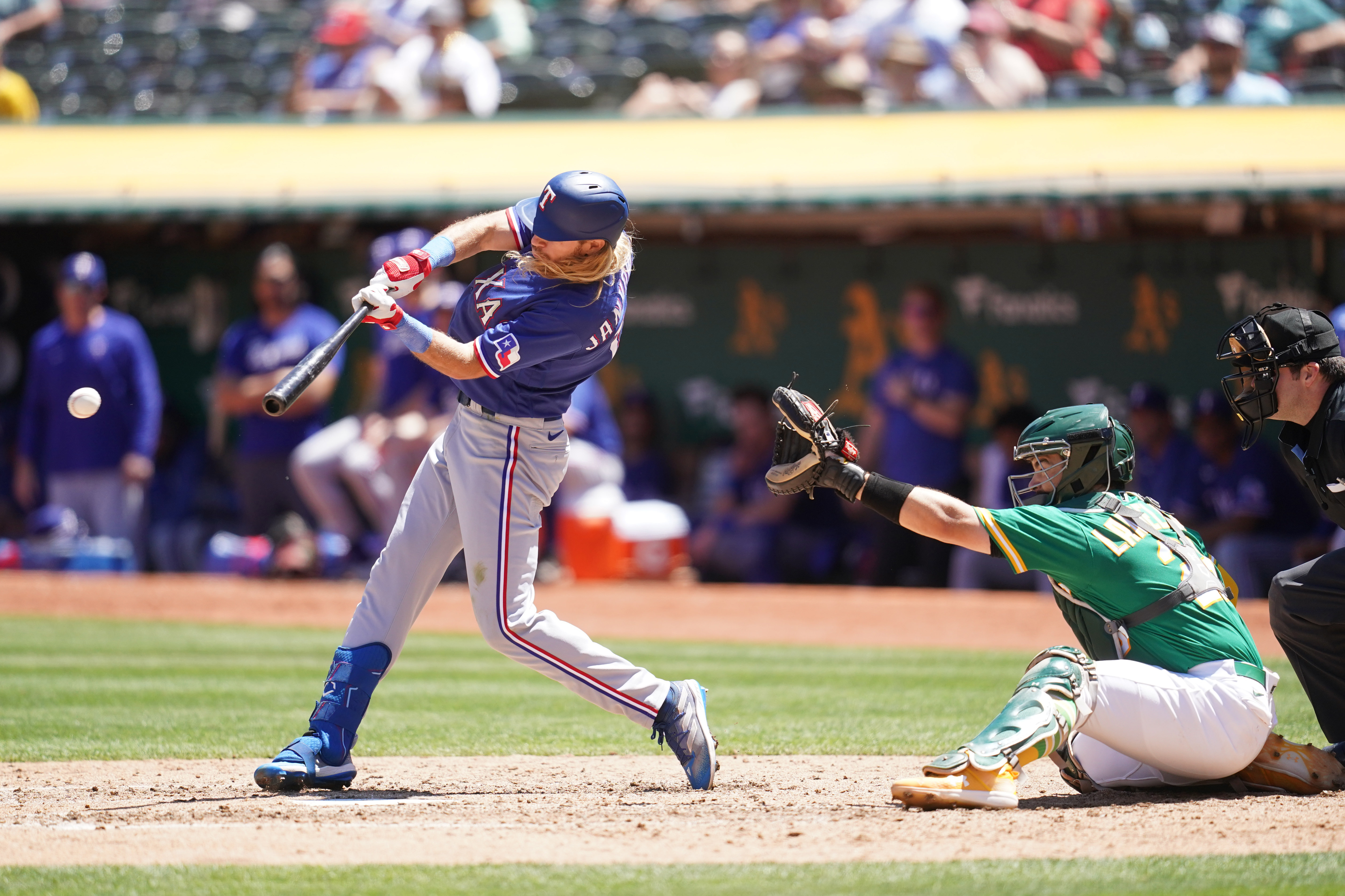 Texas Rangers center fielder Travis Jankowski reaches up to catch