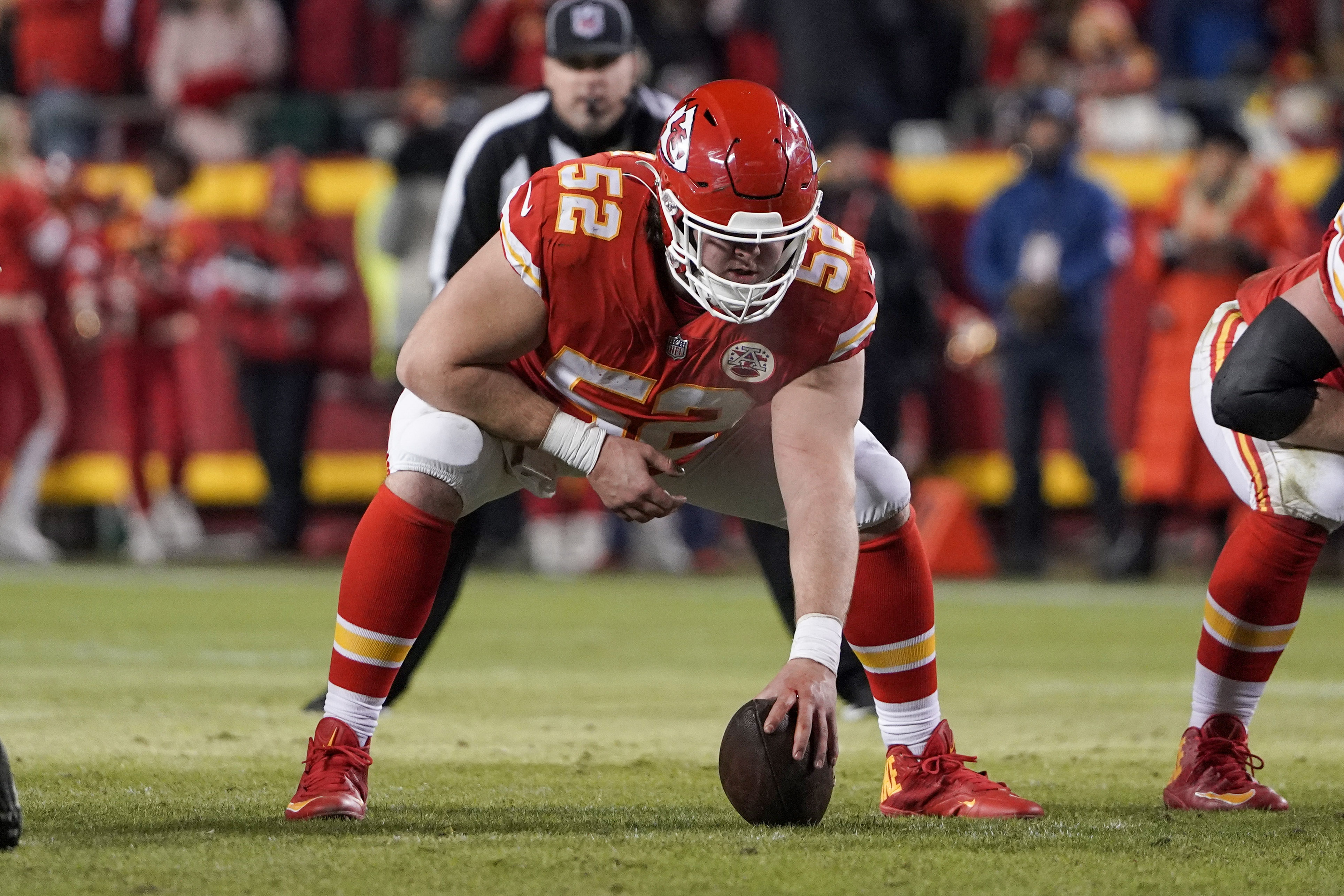 Kansas City Chiefs center Creed Humphrey (52) gets set on the line during  an NFL football