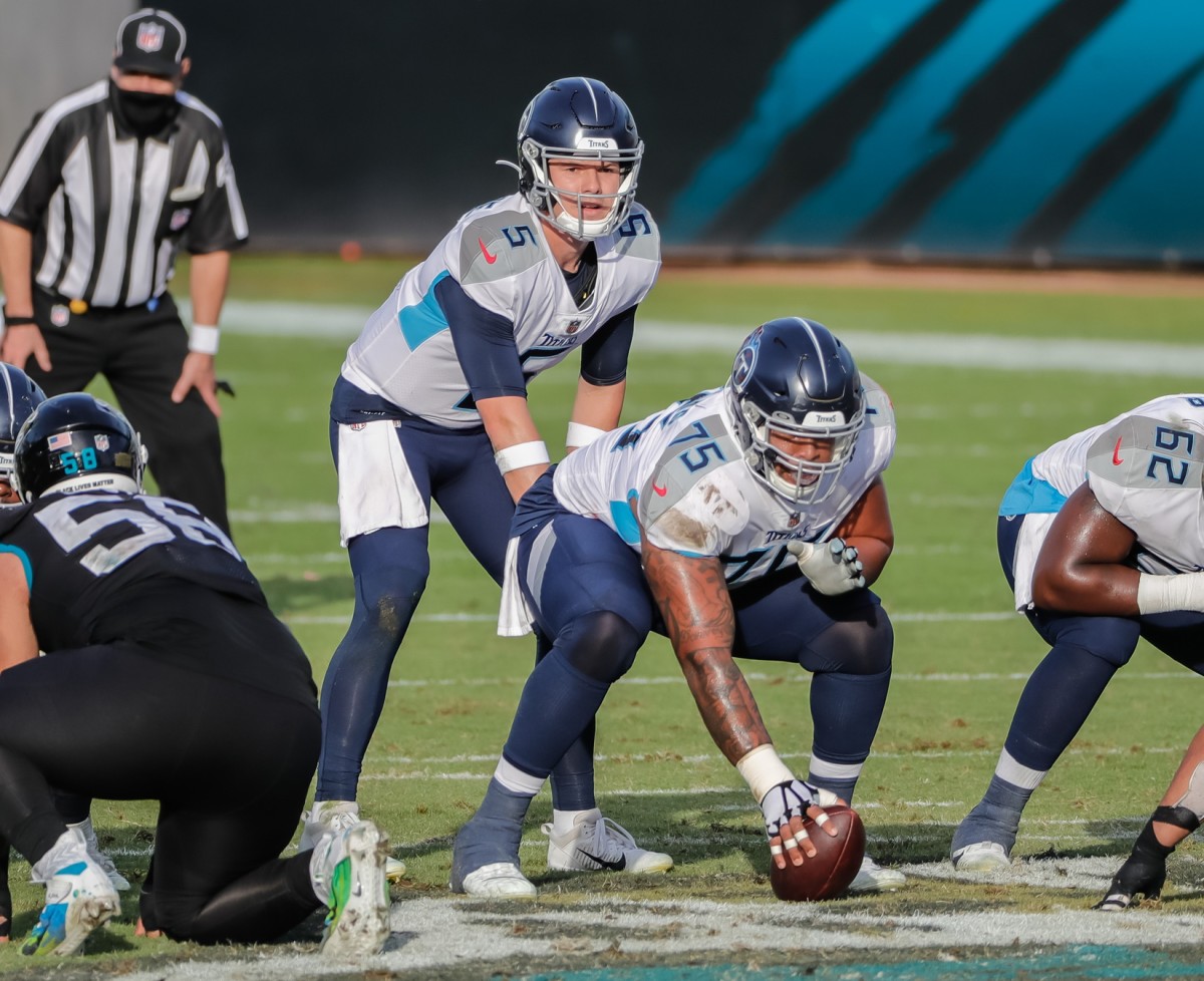 Dec 13, 2020; Jacksonville, Florida, USA; Tennessee Titans quarterback Logan Woodside (5) about to receive the snap from Tennessee Titans offensive guard Jamil Douglas (75) during the second half at TIAA Bank Field.