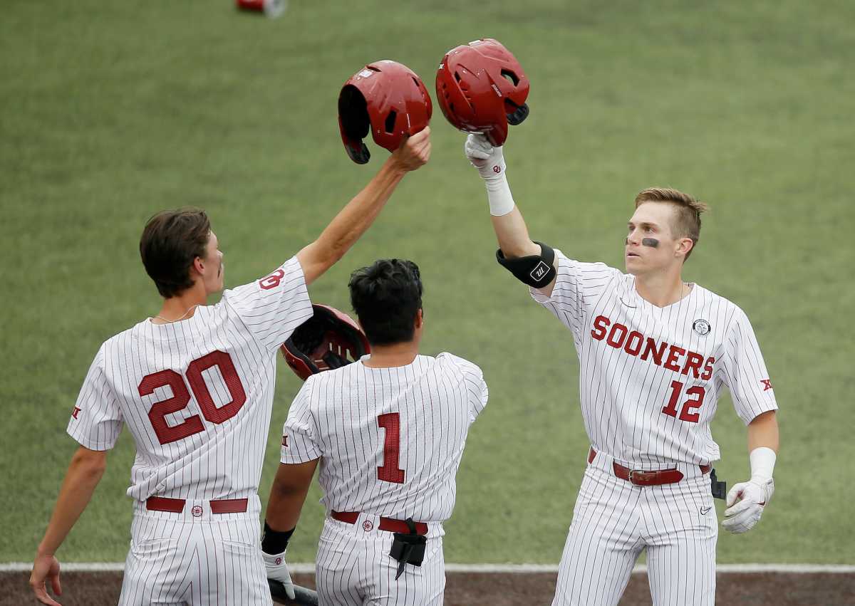 OU's Brett Squires (12) celebrates with Peyton Graham (20) and Diego Muniz (1) after hitting a home run against OSU last season. ou2