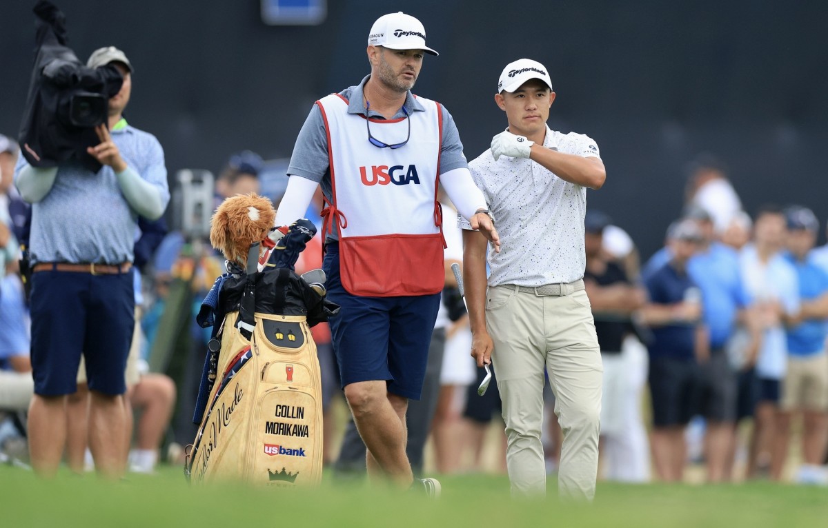 Collin Morikawa and caddie J.J. Jakovac plot his next shot.