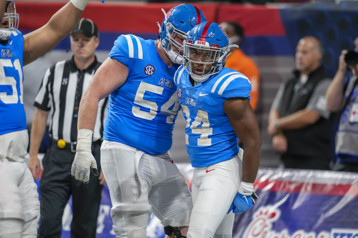 Sep 6, 2021; Atlanta, Georgia, USA; Mississippi Rebels running back Snoop Conner (24) celebrates with offensive lineman Caleb Warren (54) after scoring a touchdown against the Louisville Cardinals during the second half at Mercedes-Benz Stadium. Mandatory Credit: Dale Zanine-USA TODAY Sports