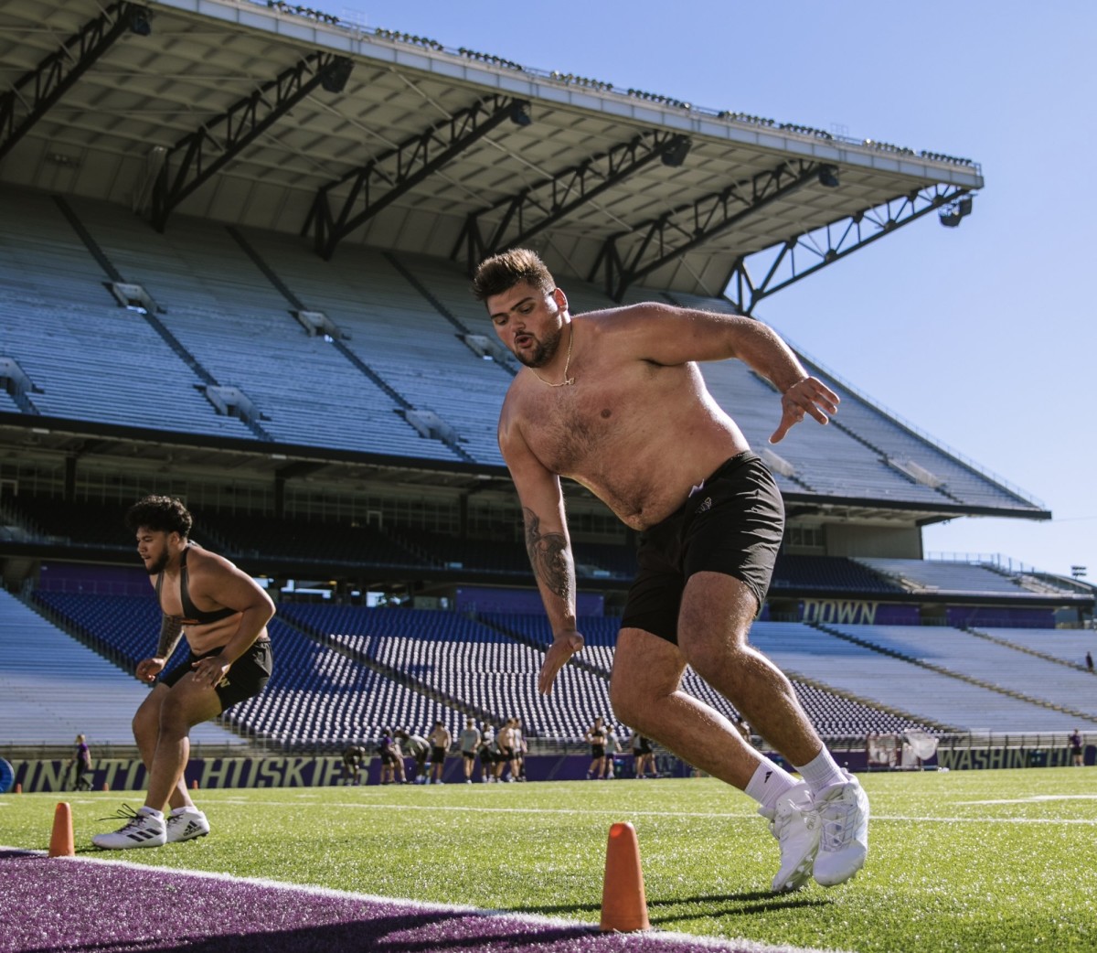 Jaxson Kirkland runs an agility drill at Husky Stadium.