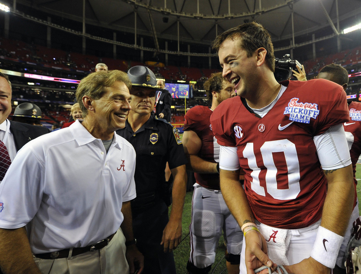 Alabama Crimson Tide quarterback AJ McCarron (10) and head coach Nick Saban react after defeating the Virginia Tech Hokies in the 2013 Chick-fil-A Kickoff game at the Georgia Dome. Alabama won 35-10.