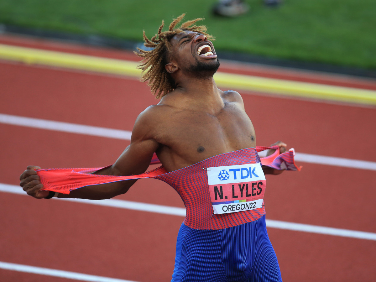 Noah Lyles rips his singlet in celebration after setting a U.S. record in the 200 meter at the world championships.