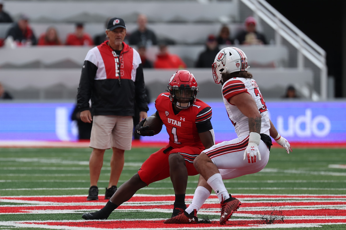 Utah Utes freshman running back Jaylon Glover (1) runs the ball as head coach Kyle Whittingham looks on in the second half of the Utah Spring Football Game at Rice Eccles Stadium.