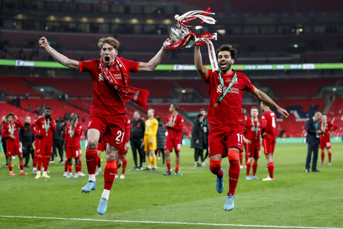 Kostas Tsimikas (left) and Liverpool teammate Mohamed Salah celebrate with the EFL Cup trophy after the 2022 final