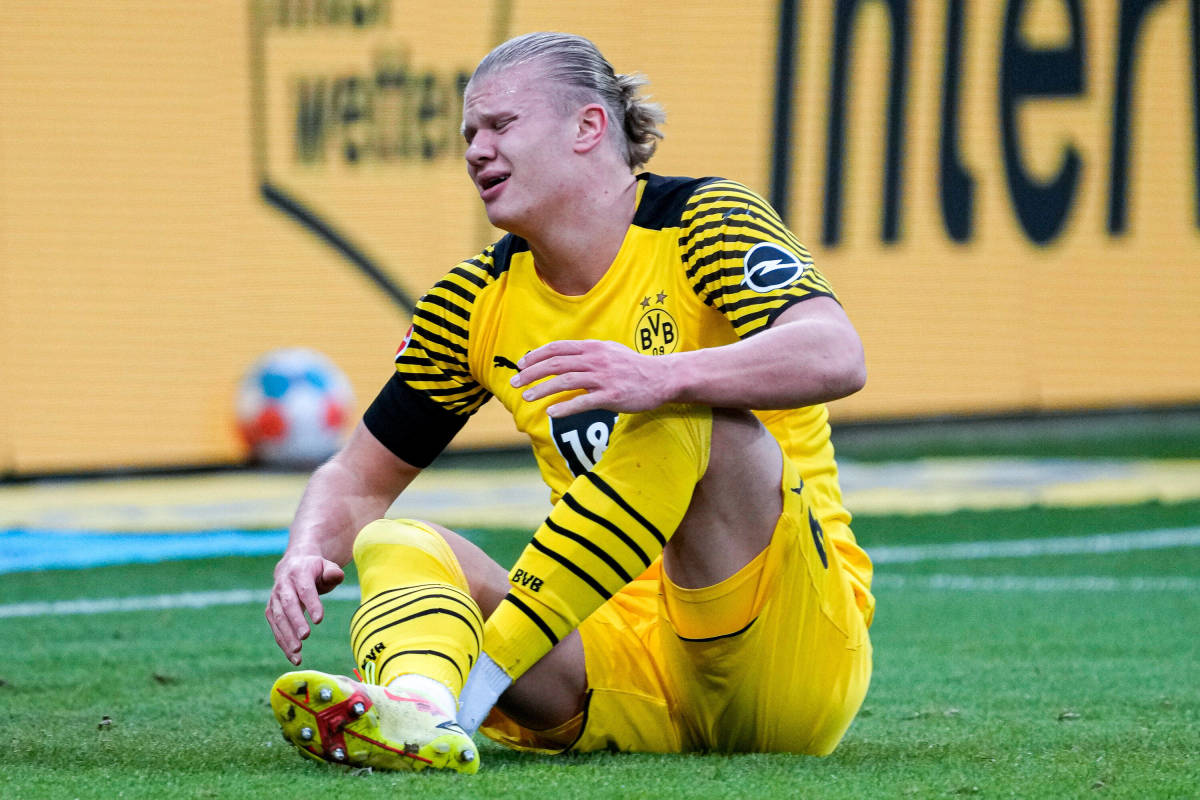 Erling Haaland pictured looking pained after suffering an injury in Borussia Dortmund's game with Hoffenheim in January 2022