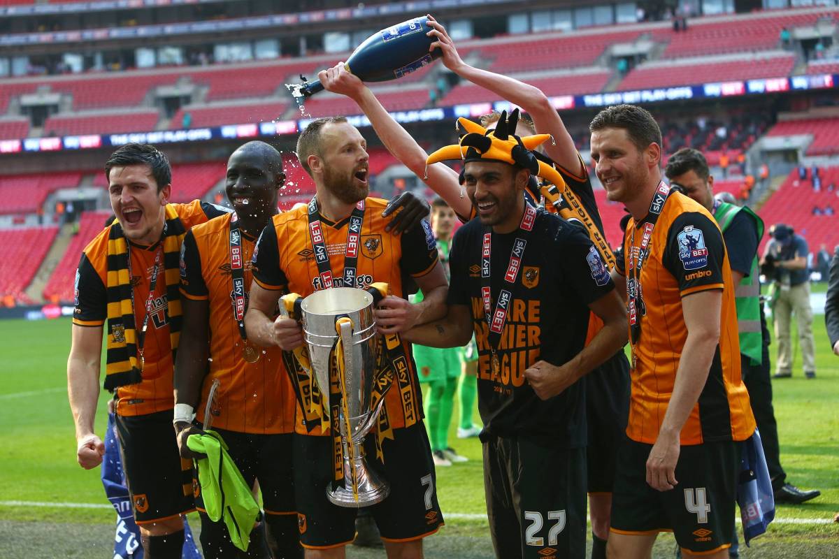 Harry Maguire (left) and Ahmed Elmohamady (wearing hat) pictured celebrating Hull City's promotion to the Premier League in 2016