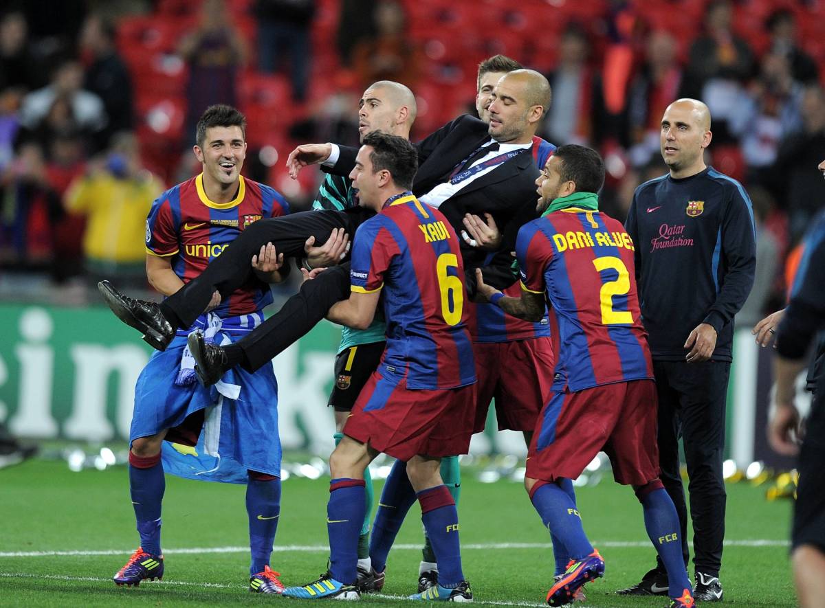 No 6 Xavi Hernandez and his Barcelona teammates lift up Pep Guardiola after winning the 2011 Champions League final