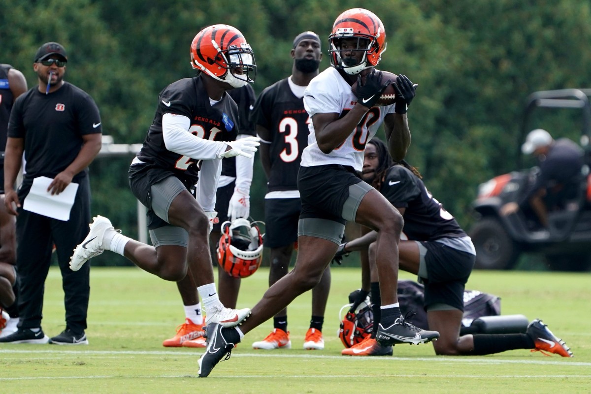 FILE - Cincinnati Bengals' Joe Mixon (28) and Orlando Brown Jr. (75) walk  onto the field during practice at the team's NFL football training  facility, Tuesday, June 6, 2023, in Cincinnati. The