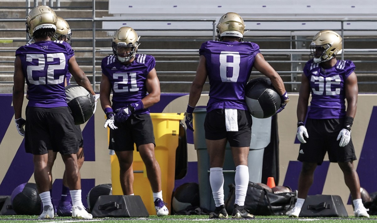 New backs Wayne Taulapapa (21) and Will Nixon (8) mix with holdover Cam Davis (22) and spring arrival Aaron Dumas (32).