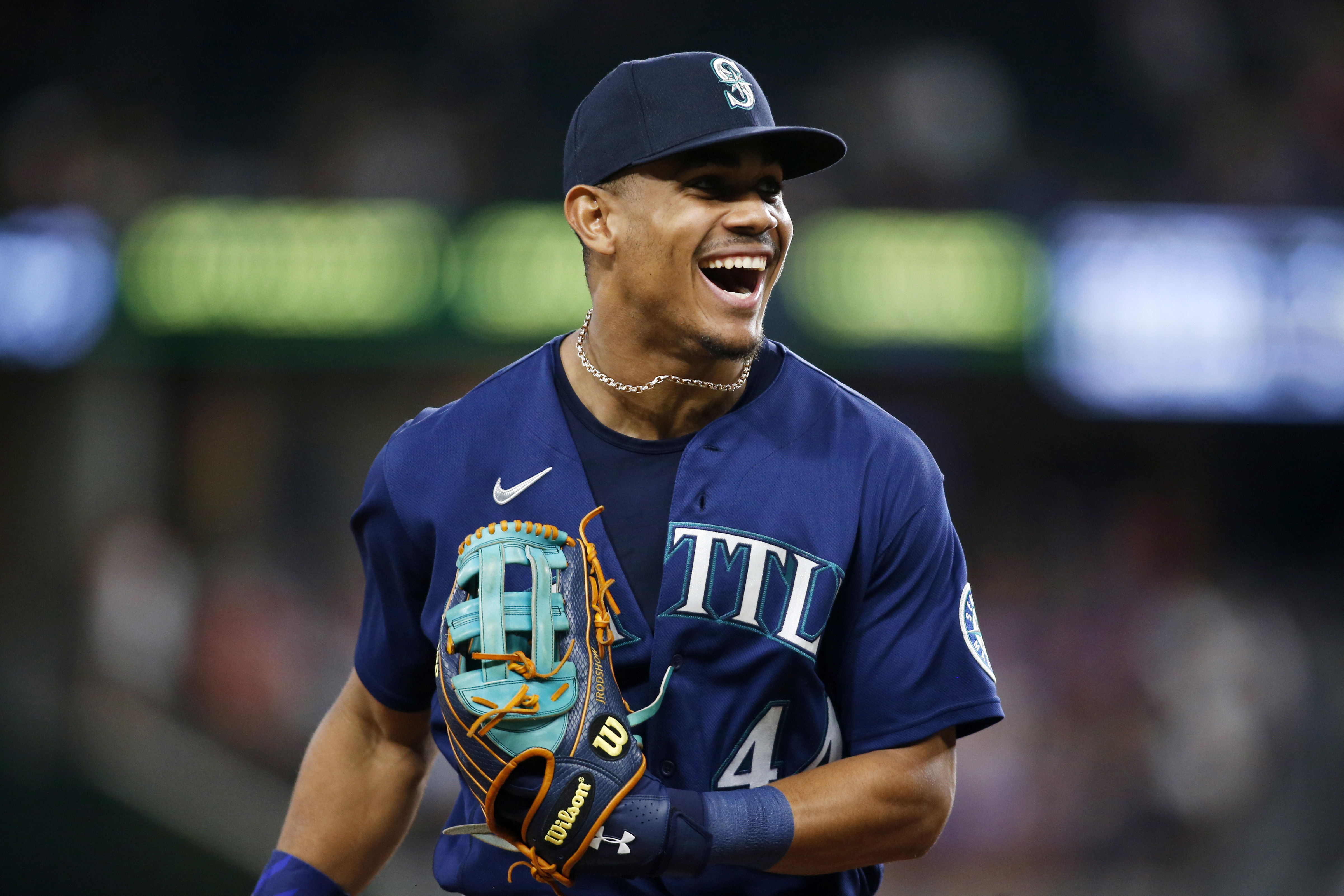 Seattle Mariners' Julio Rodriguez smiles while standing next to