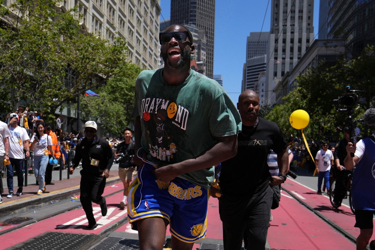 Jun 20, 2022; San Francisco, CA, USA; Golden State Warriors forward Draymond Green runs during the Golden State Warriors championship parade in downtown San Francisco. Mandatory Credit: Darren Yamashita-USA TODAY Sports