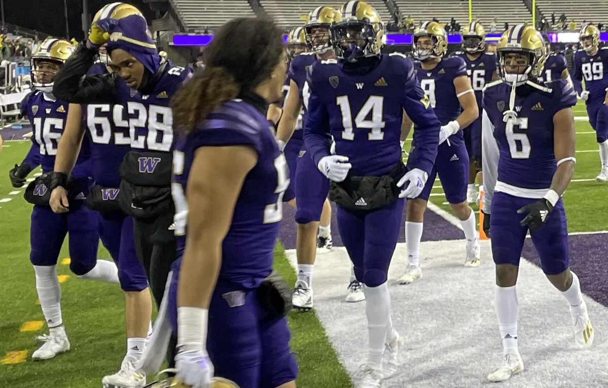 Vince Nunley (28) leaves the field after the Oregon game, along with Davon Banks (16) and Zhakari Spears (14).