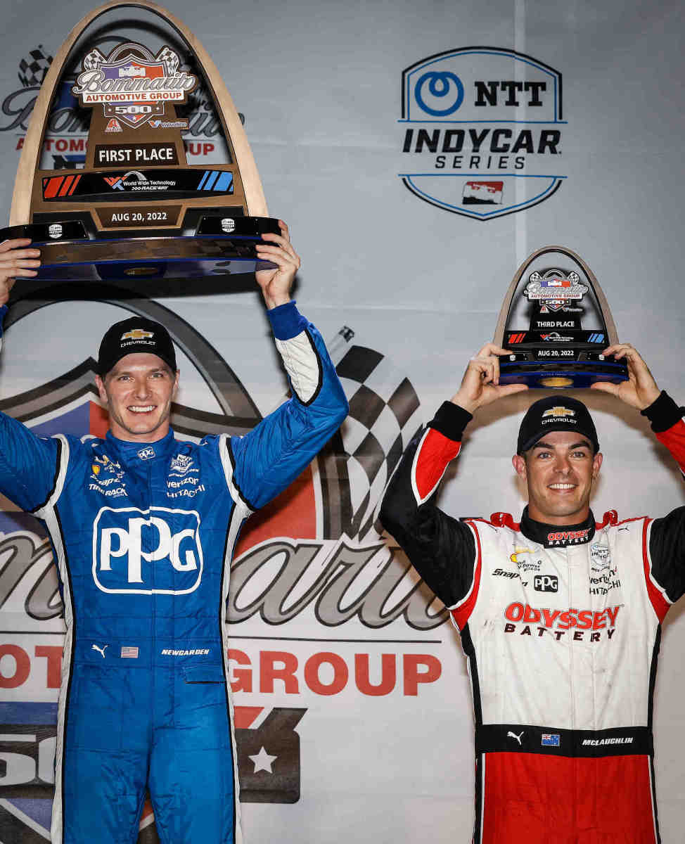 Josef Newgarden celebrates his win on the podium with 3rd-place finisher and Team Penske teammate Scott McLaughlin following Saturday's NTT IndyCar Series Bommarito Automotive Group 500 race at World Wide Technology Raceway near St. Louis. (Photo by Michael L. Levitt/LAT for Chevy Racing)