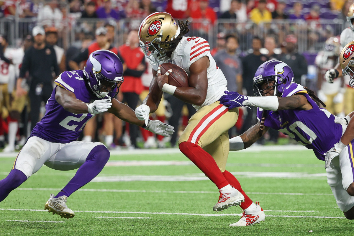 San Francisco 49ers running back Jordan Mason (24) runs with the ball  during the first half of an NFL preseason football game against the Los  Angeles Chargers, Friday, Aug. 25, 2023, in