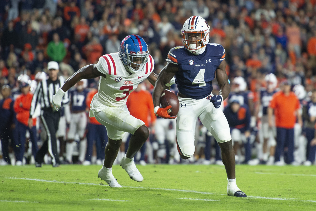 AUBURN, ALABAMA - OCTOBER 30: Running back Tank Bigsby #4 of the Auburn Tigers runs the ball by defensive back Otis Reese #3 of the Mississippi Rebels during the first quarter of play at Jordan-Hare Stadium on October 30, 2021 in Auburn, Alabama. (Photo by Michael Chang/Getty Images)