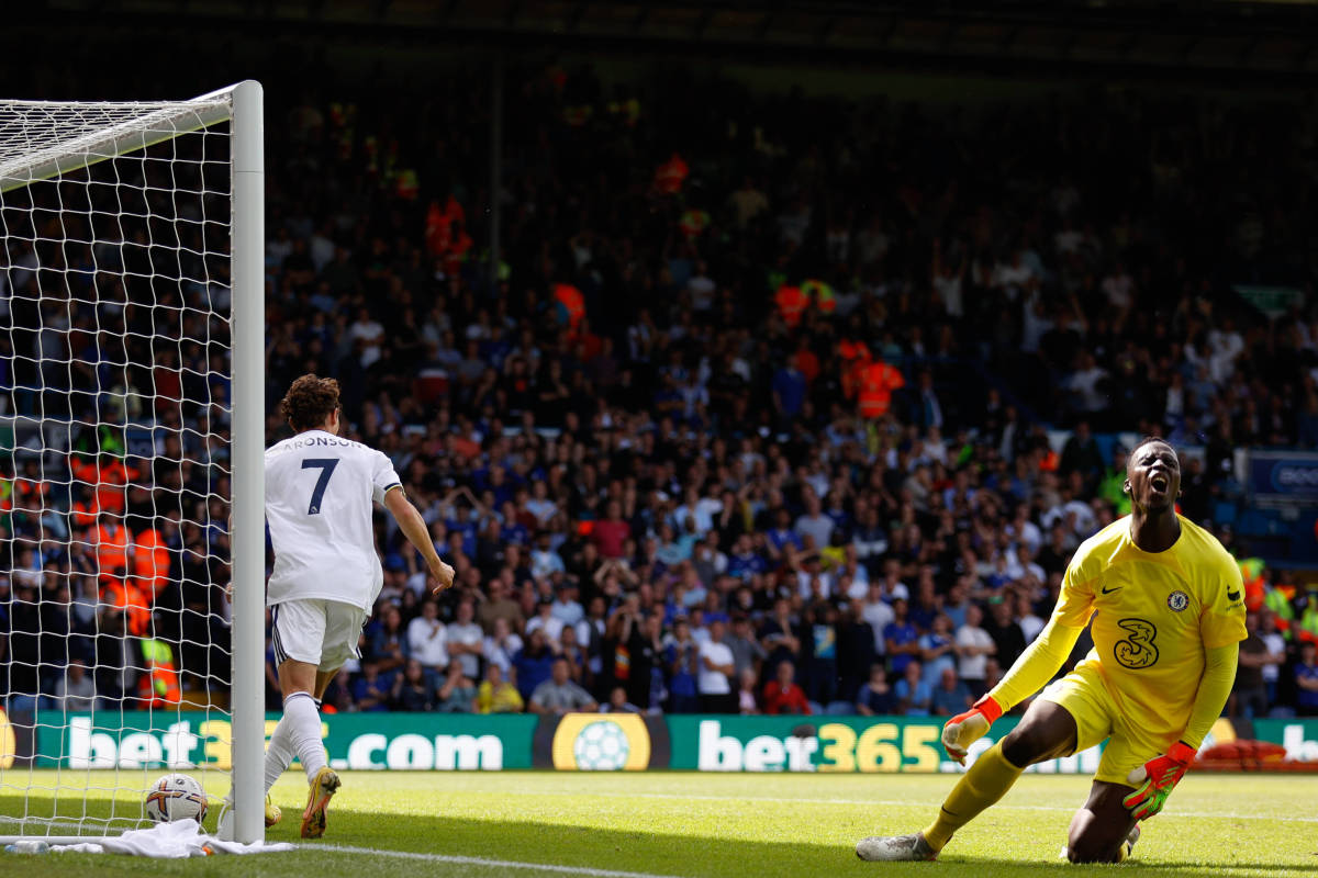 Leeds United no.7 Brenden Aaronson pictured scoring his first Premier League goal in August 2022 after tackling Chelsea keeper Edouard Mendy (right)