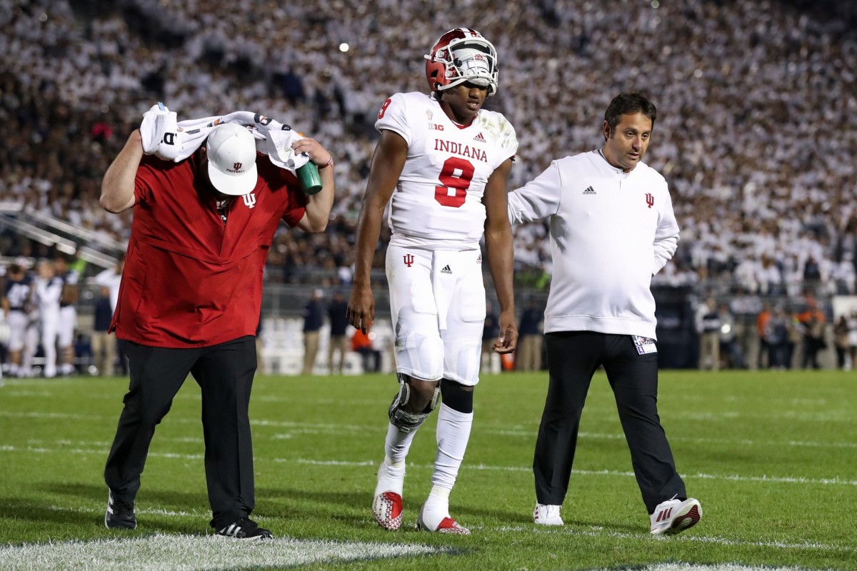 Michael Penix Jr. is helped off the field after his final injury for Indiana at Penn State.