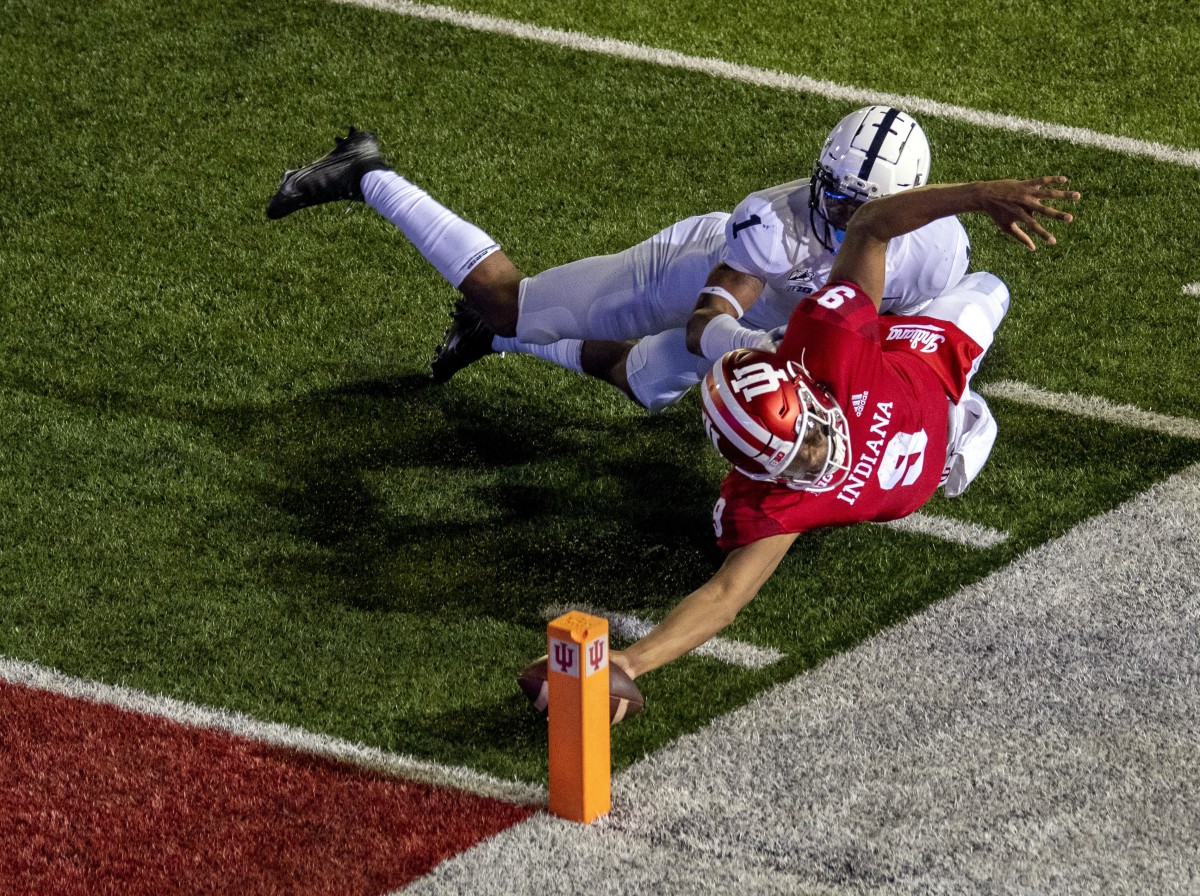 Michael Penix Jr. reaches to score a game-winning conversion run to beat Penn State in overtime 36-35.