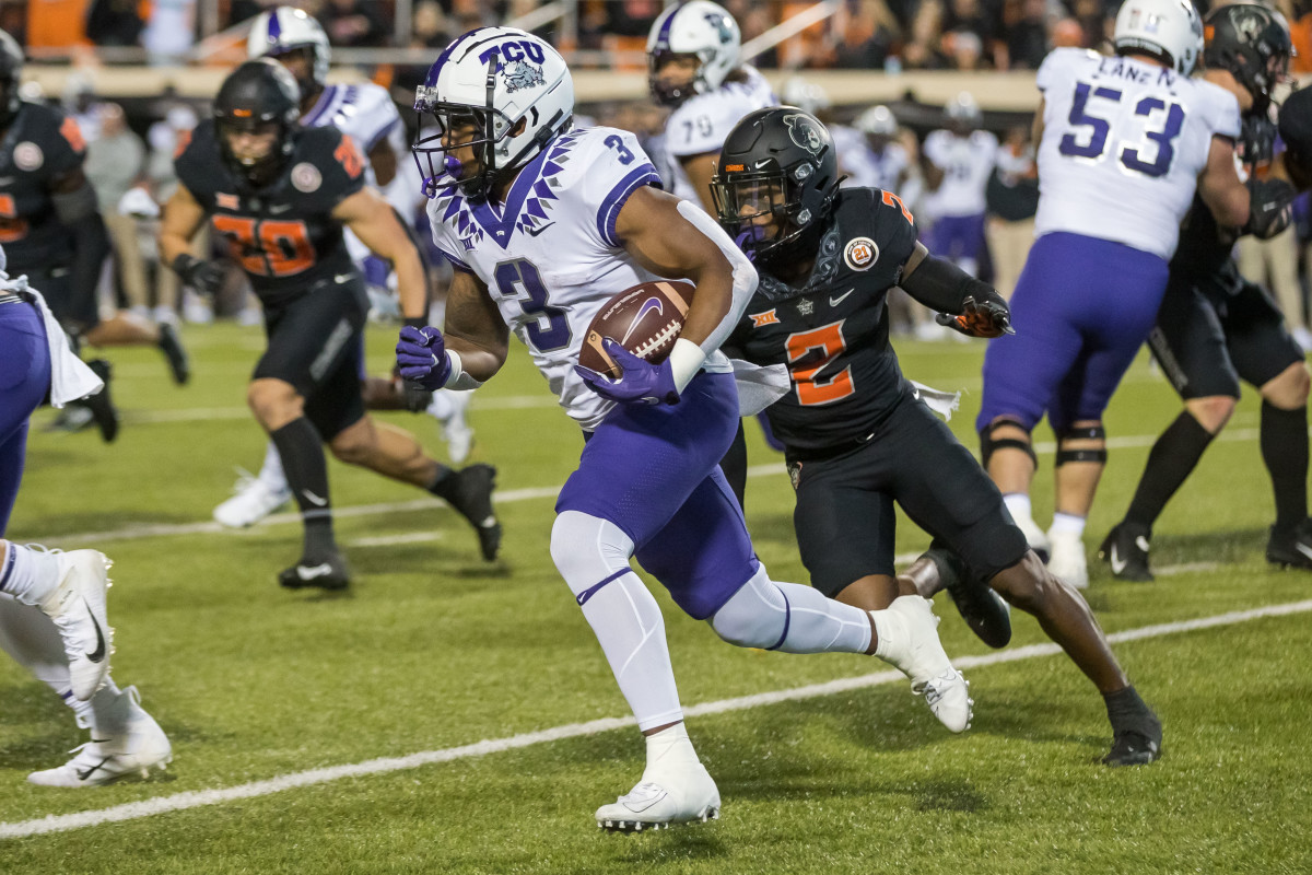 Nov 13, 2021; Stillwater, Oklahoma, USA; TCU Horned Frogs running back Emari Demercado (3) gets around Oklahoma State Cowboys safety Tanner McCalister (2) during the second quarter at Boone Pickens Stadium.