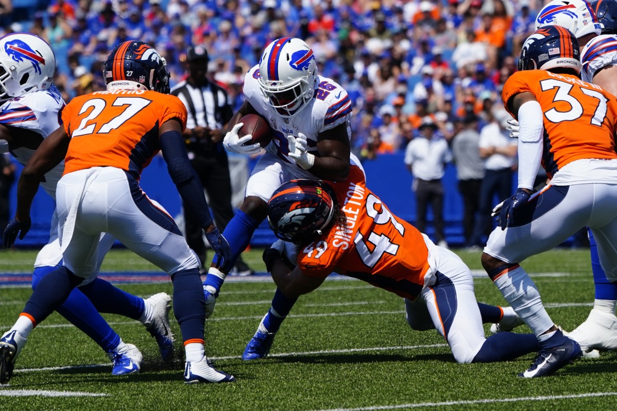 Denver Broncos linebacker Alex Singleton (49) tackles Buffalo Bills running back Devin Singletary (26) with the ball during the first half at Highmark Stadium.