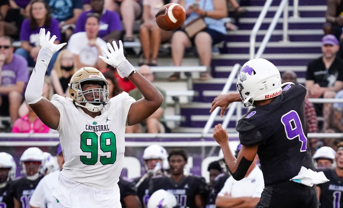 Cathedral Fighting Irish Kendrick Gilbert (99) attempts to block a pass from Brownsburg Bulldogs quarterback Jayden Whitaker (9) on Friday, August 27, 2021, at Brownsburg High School, Brownsburg.