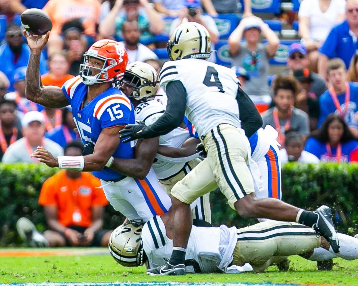 Florida Gators quarterback Anthony Richardson (15) makes a pass as he is tackled in the first half. The Florida Gators lead 21-0 at the half over the Vanderbilt Commodores.