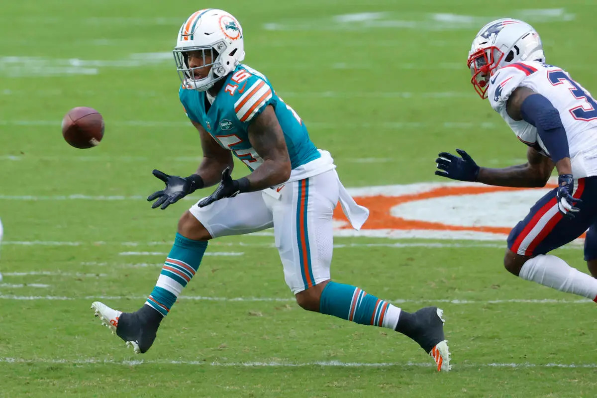 Miami Dolphins running back Lynn Bowden (15) runs after a catch against the  New England Patriot …