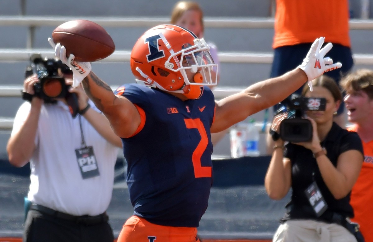 Illinois Fighting Illini running back Chase Brown (2) reacts after scoring a touchdown in the first half against Wyoming at Memorial Stadium.