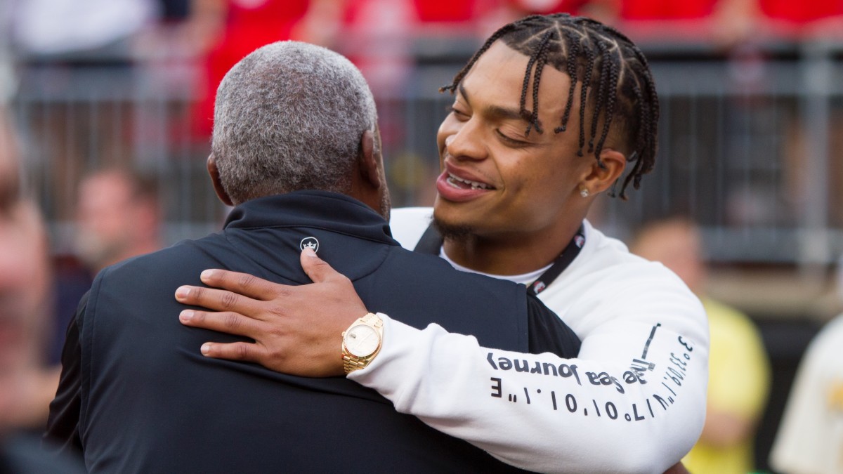 Justin Fields hugs Ohio State Athletic Director Gene Smith