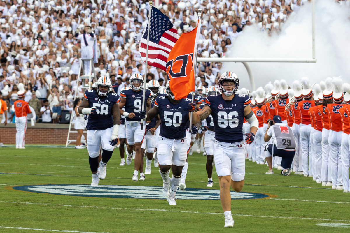 Luke Deal and Jalil Irvin lead the Auburn football team out on the field against Mercer.