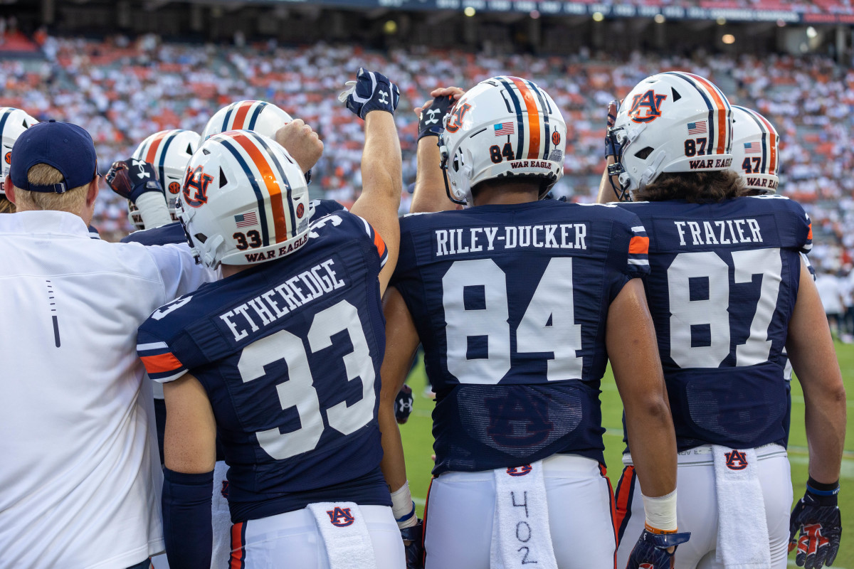 Camden Etheridge, Micah Riley-Ducker, and Brandon Frazier on the sideline vs the Mercer Bears.