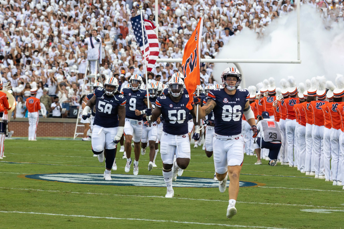 Luke Deal and Jalil Irvin lead the Auburn football team out on the field against Mercer.