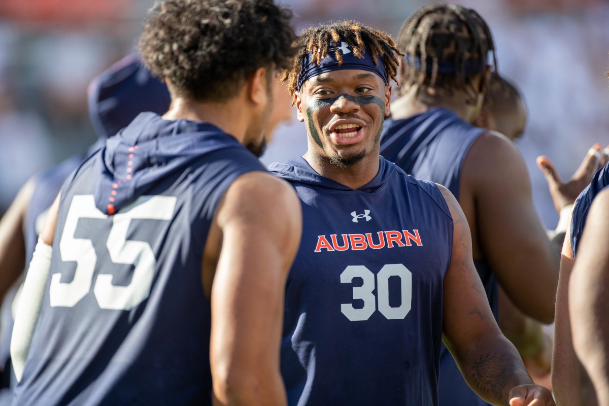 Auburn linebacker Desmond Tisdol speaks with Auburn EDGE Eku Leota pregame before Auburn vs Mercer.